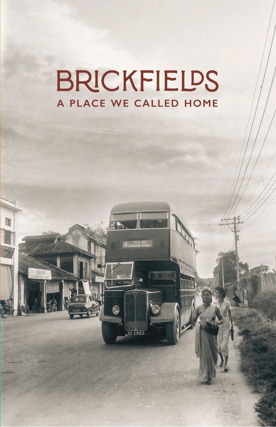 Cover of Brickfields: A Place We Called Home. Features an old-style double story bus and two women walking beside it.
